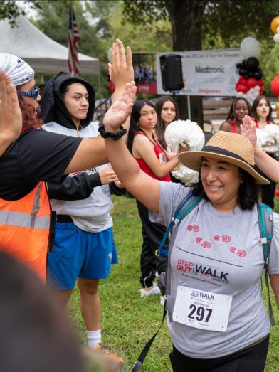 People in a community giving high fives after Step Out Walk