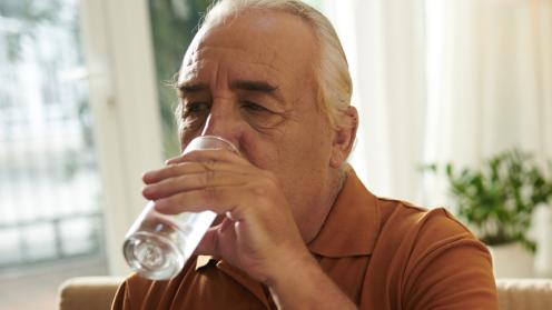 Senior man drinking glass of water