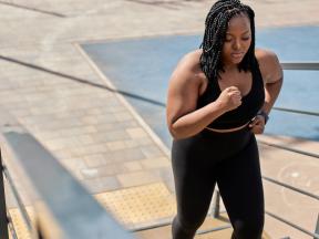 African american woman exercising, running upstairs outdoors