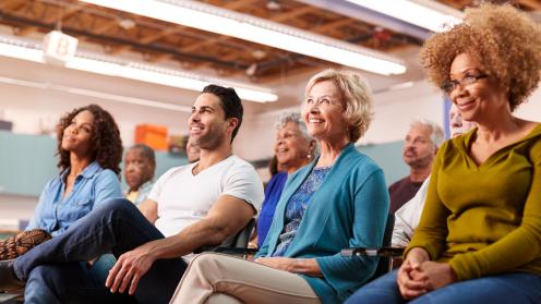 People sitting at town hall meeting