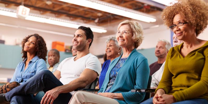 People sitting at town hall meeting