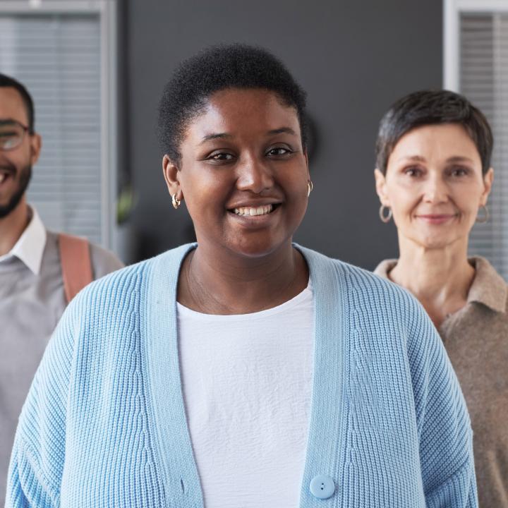 Group of smiling individuals standing together 