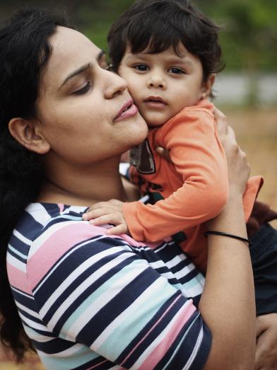 Mother holding toddler son