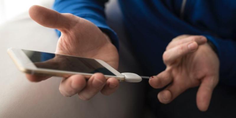 Person checking blood glucose with meter