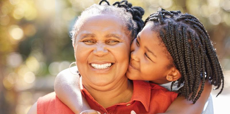 Smiling African American grandmother and granddaughter