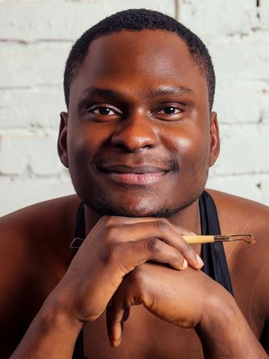 African American man holding sculpting tool