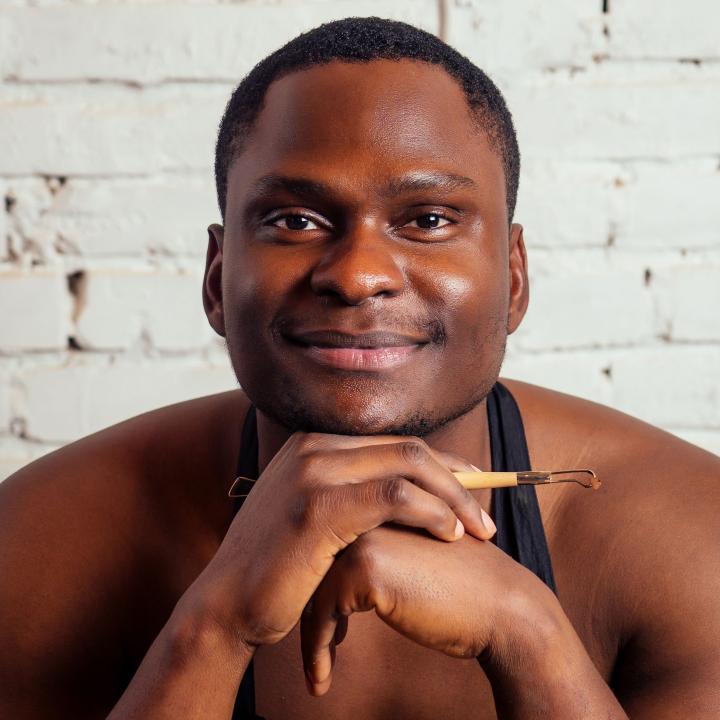 African American man holding sculpting tool