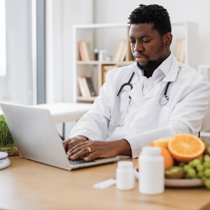 African American Doctor working on laptop