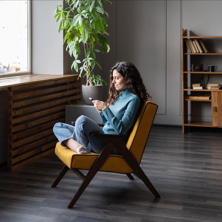 Woman sitting in chair shopping on her smartphone