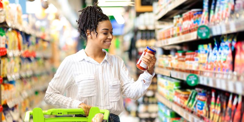 Happy african american woman doing groceries shopping