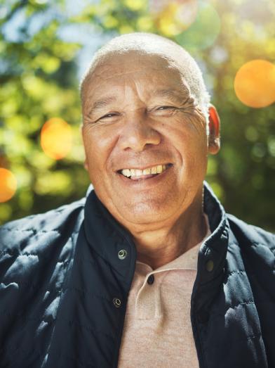 Smiling senior man outside on beautiful sunny Fall day