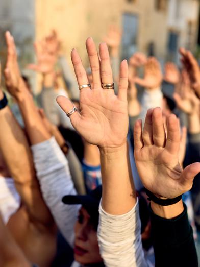 crowd with raised hands