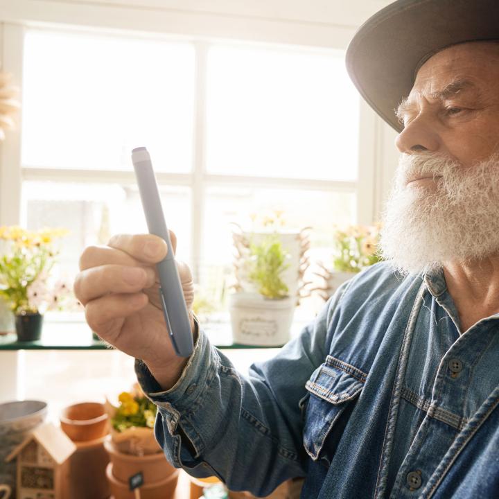 Senior man holding insulin pen