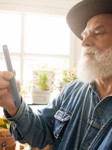 Senior man holding insulin pen