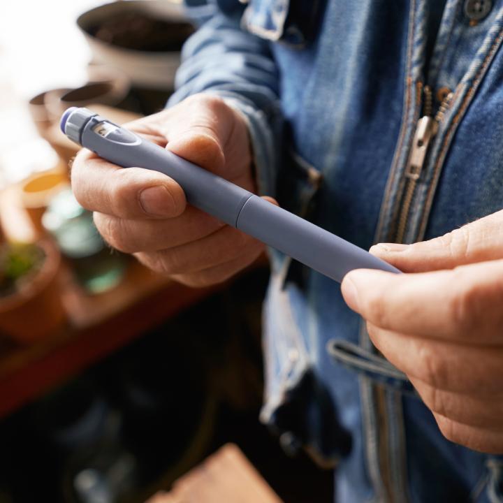 Man holding insulin pen