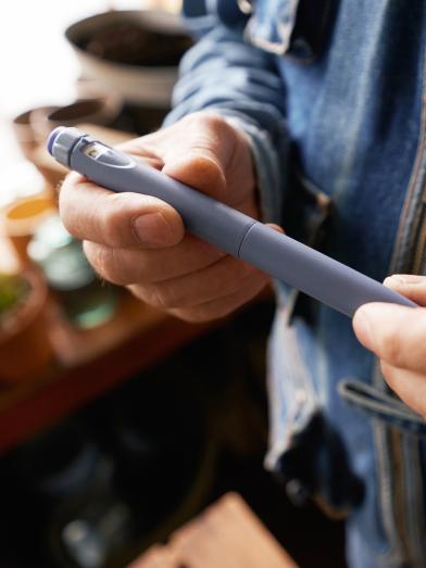 Man holding insulin pen