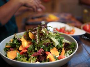 Colorful bowl of leafy salad greens