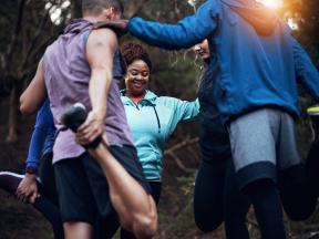 Group of people stretching outdoors before exercise