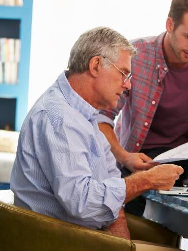 Father and son looking at donation giving materials