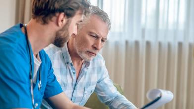 Senior man discussing diagnosis with doctor