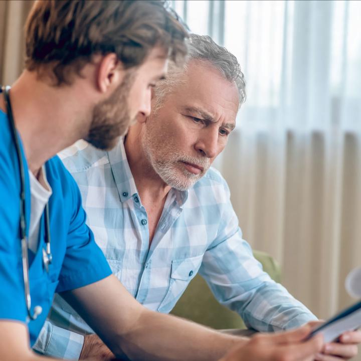 Senior man discussing diagnosis with doctor