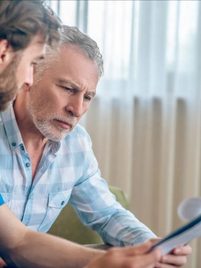 Senior man discussing diagnosis with doctor