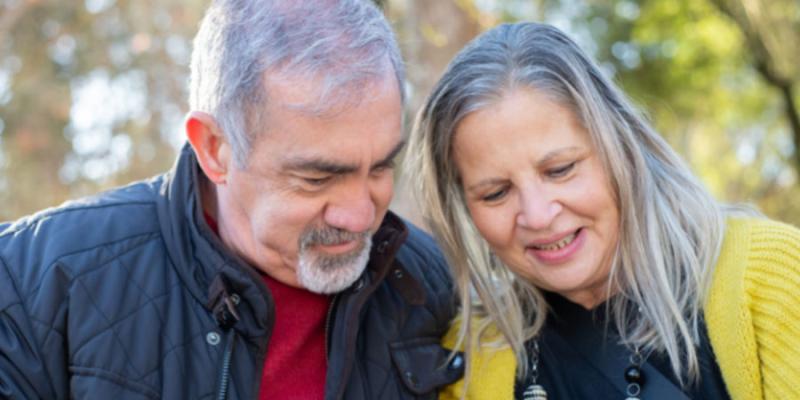 a senior couple looking at a mobile device together