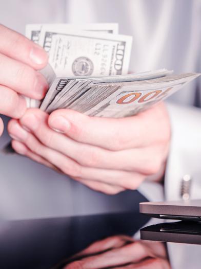 A man holding Dollars bill