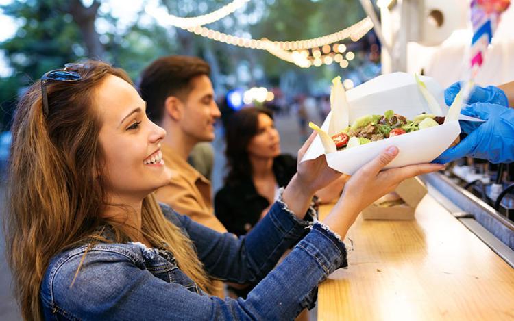 Woman ordering healthy food from food truck