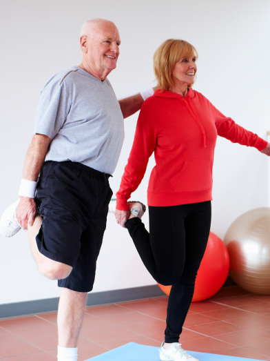 Two seniors balancing on one leg