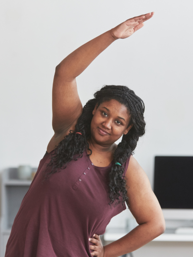 A black woman stretches before exercising.