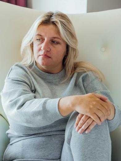 Depressed woman sitting in a chair