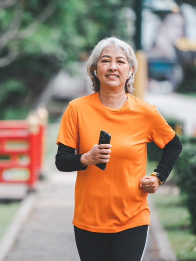 white haired elderly person exercising in the park