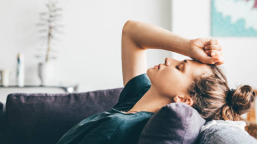 women laying on couch